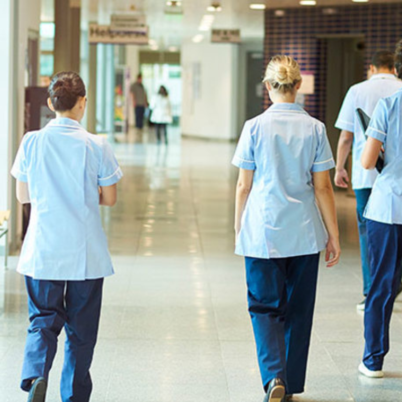 Medical professionals walking through hospital