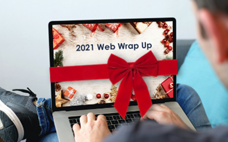 2021 web wrap up written on a laptop screen with a bow on it