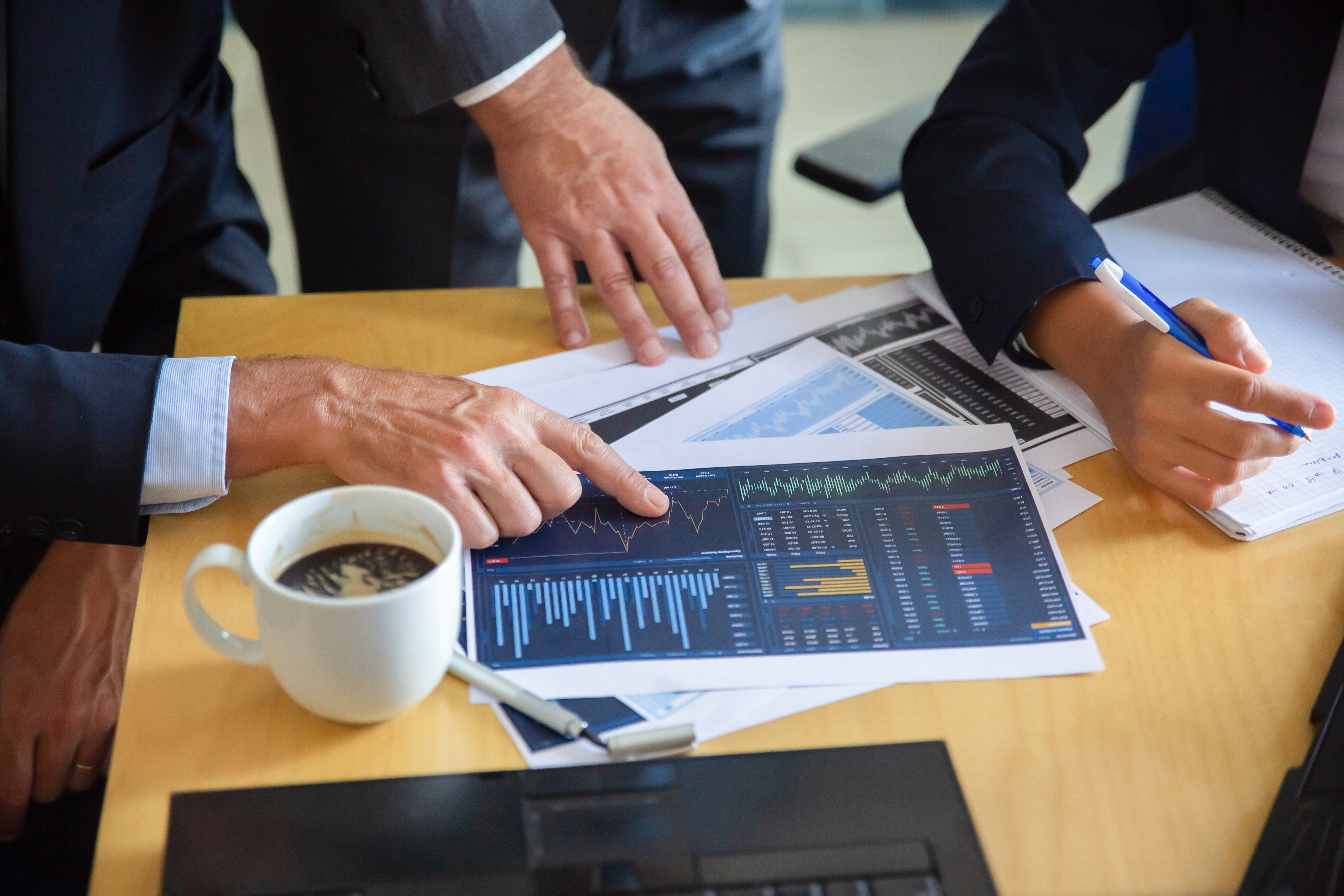 Unrecognizable Businessman Pointing Printed Chart Showing Graph Colleagues Professional Content Partners Making Notes Statistics Cooperation Communication Partnership Concept